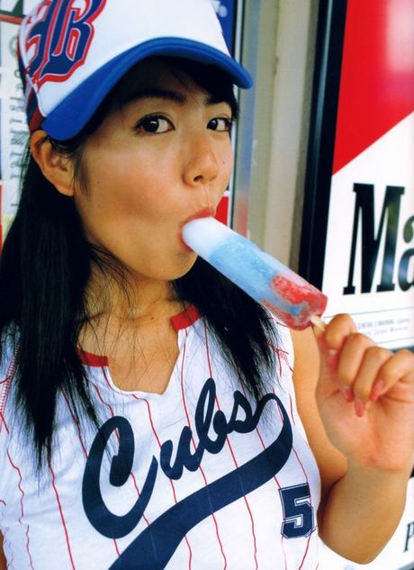 Sizzling asian with juicey pink lips sucking on a big popscicle