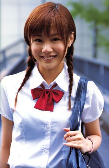 Cute asian girl is flirtatious with her long hair in a dress