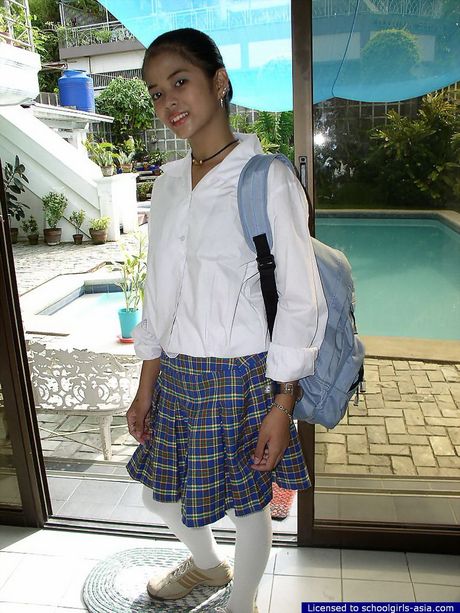 Slim young chick stripping of her school uniform to flash her neat vagina