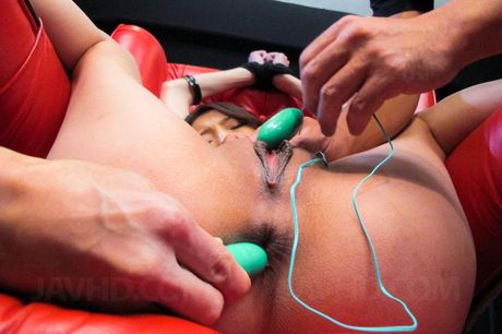 Ibuki in a red chair legs spread with a toy stuffed deep