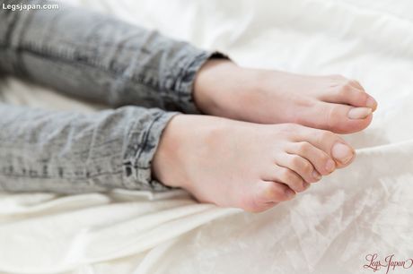 Skinny Asian teen Kamimoto Rio strips and rides a big dick on a bed