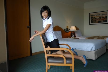 Japanese babe strips and shows her tiny tits and pussy