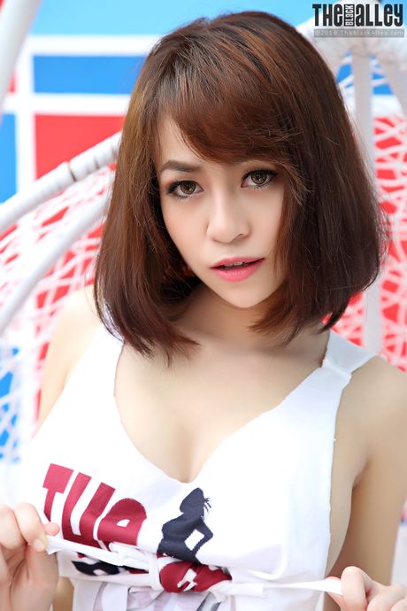 Asian teen Eileen strips and shows her hairy pussy up close