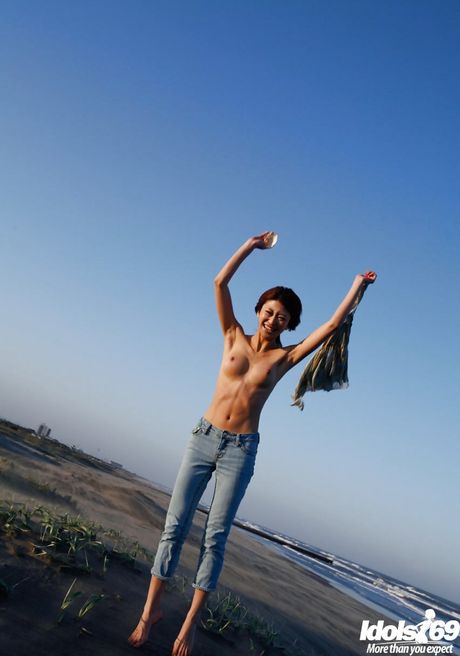 Hot japanese teen Yu Satome in jeans shows big hooters and sexy butt at beach